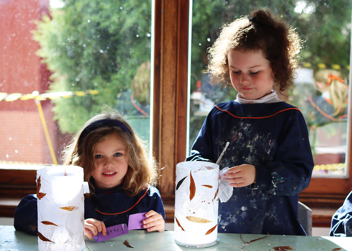 Prep students creating leaf lantern art with a specialist Art teacher